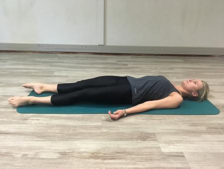 You are going to gently press your lower back into the floor trying to use your abdominals and you may use a little bit of glutes. As you press the back down, extend your knees into the floor.