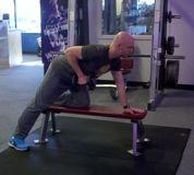 Hold the dumbbell in the right hand in full extension and slowly row it up to the