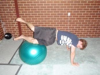 Making sure you keep your core braced, rotate your hips one direction until the side of your knee is on the ball,