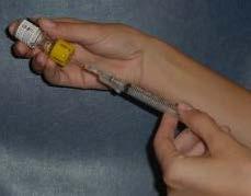 6. Take the cap off of the syringe needle. Insert the needle into the vial 7.