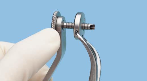 Rotate the knurled collar on the drill guide to move the cheek retractor ring up the drill guide. Disengage the forceps from the cheek retractor. Retract the soft tissue as needed.