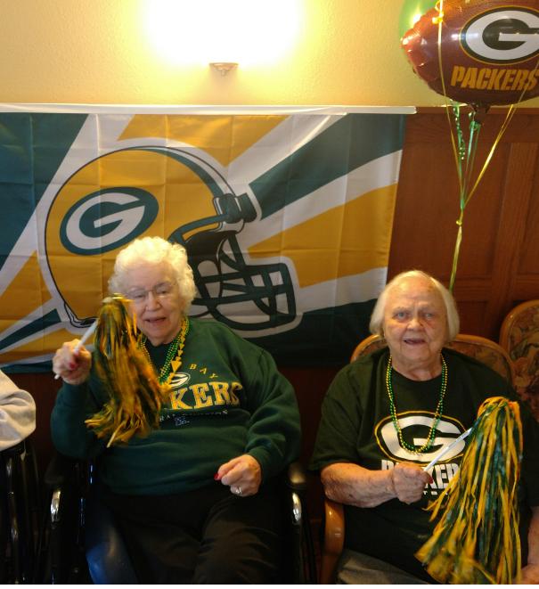 Left: Betty enjoys the refreshments while watching the game with