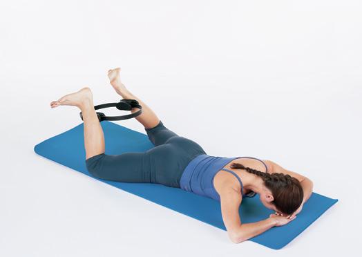 Heel Squeeze Prone Tricep Press Starting position: Lying on stomach on mat with hands under forehead; knees bent