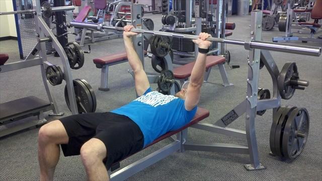 Keeping your elbows close to your sides, lower the bar straight down to the bottom of your chest. 5.