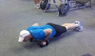 Start in a push-up position as you grip a pair of
