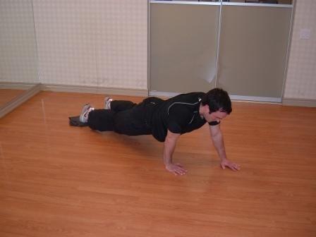 Alligator Crawl Start from a push-up position with your feet on a towel.