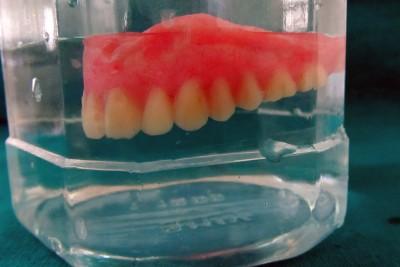 4 Placement of denture in water at room temperature to