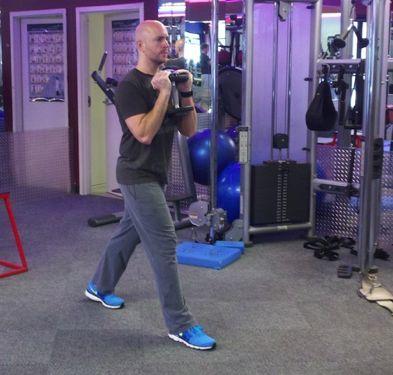 Workout C Goblet Split Squat Stand with your feet shoulder-width apart and hold a dumbbell in front of your chest.