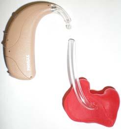 To wash the earmoulds you need to remove them from the hearing aids. To do this, hold onto the tubing with one hand and the hearing aid in the other and ease the two bits apart, as shown.