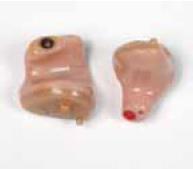 You must not wash these types of hearing aids (see picture on the left). Wipe them with a dry tissue and use a soft, dry brush to remove wax from the opening.