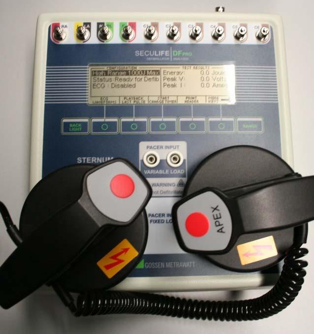 As soon as the defibrillator issues a command to trigger shock, press both red buttons on the paddles for approximately 5 seconds and press the paddles firmly