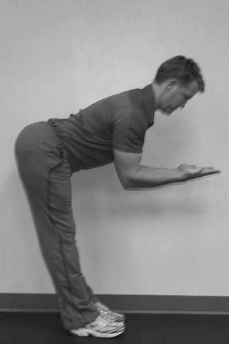 Bend forward at the hips sticking your buttocks out behind you but keeping your legs straight.