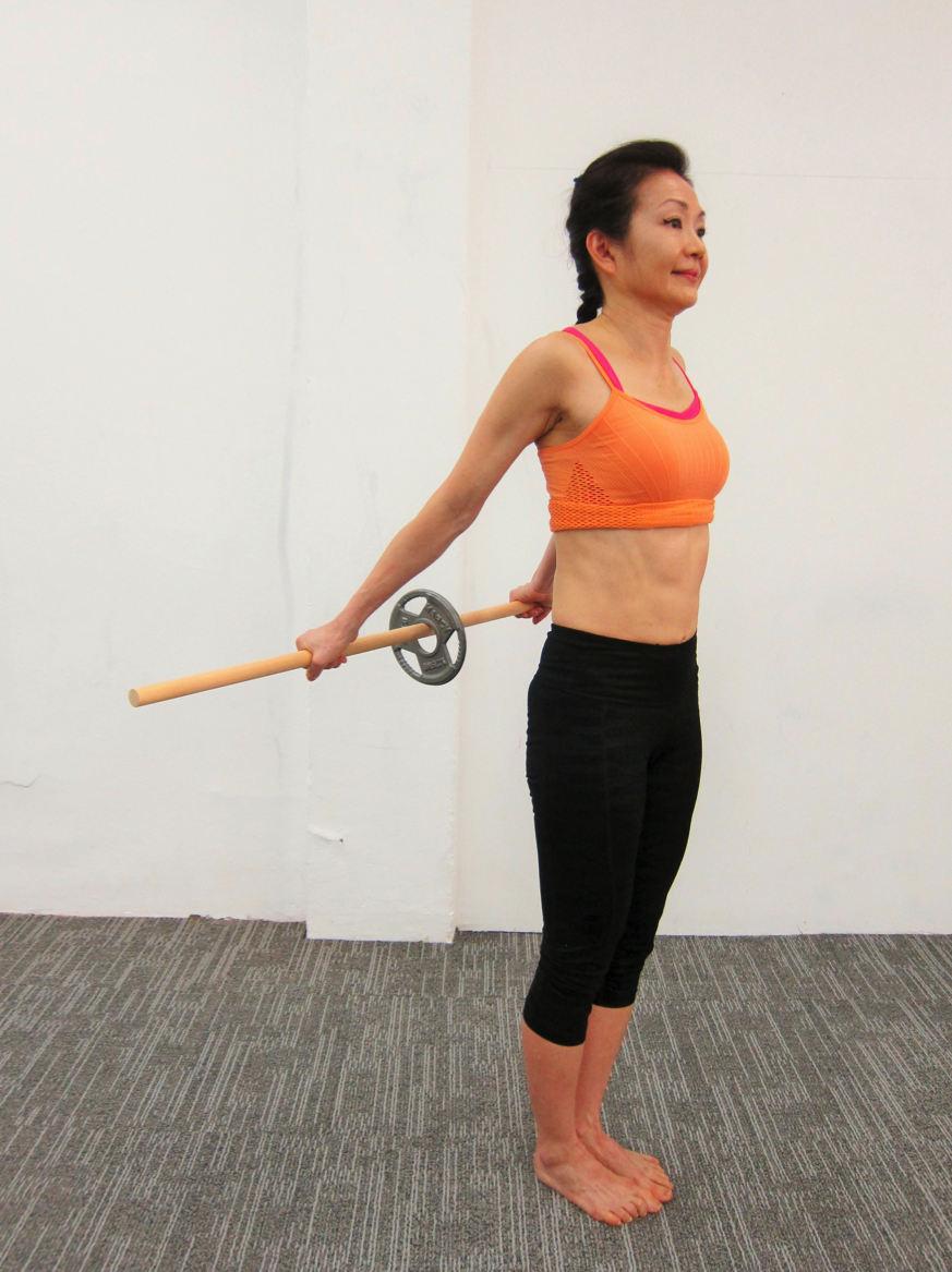 4. Static standing Shoulder extension with weighted dowel Mobilize Shoulder Girdle Stand holding weighted dowel behind hips at shoulder width apart with a under grip [Photo 4A ].