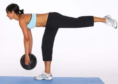 Keeping the shoulders back, abs in and the back straight, tip from the hips and lower the weights towards the floor.