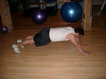 Start in a modified push-up position, with your hands out in front of your shoulders.
