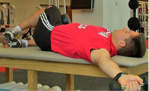 Lie on elevated surface, with light dumbbell in left hand, lower arm over edge. 2.