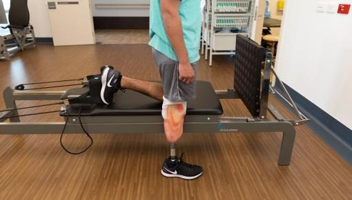 Standing hip extensions with reformer Stand beside the reformer on your