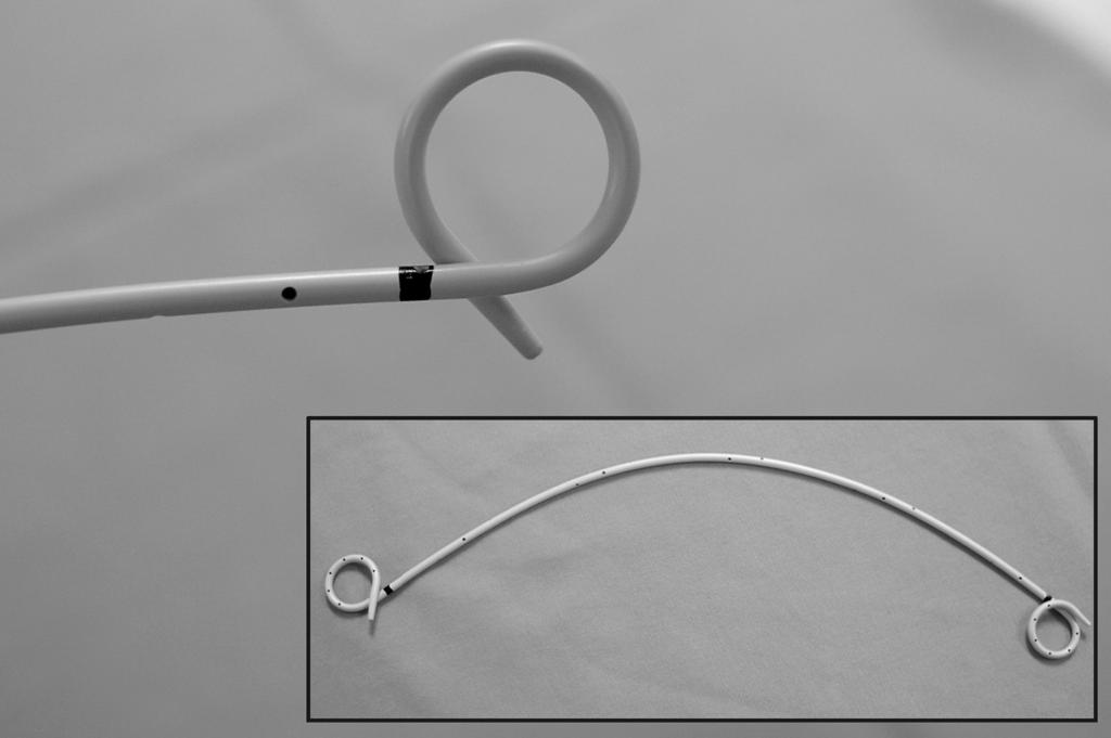 (Curl magnified) Sideholes aid in drainage and the black mark on either end of the stent facilitate visualization of the curl when placing a stent visually through the cystoscope.