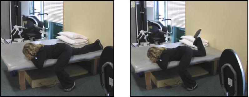6. Prone Hip Extension/Posture Stretch Treatment: Begin by lying on your stomach on the side of your bed with one foot off of the edge and on the floor as shown.