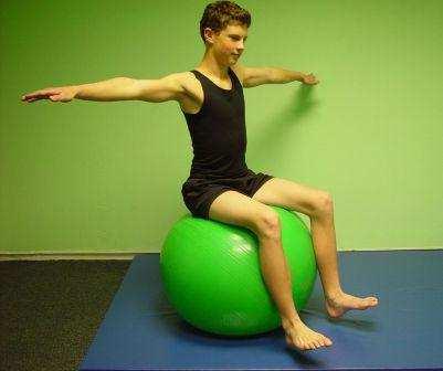 BALANCE: 21. SEATED LEG LIFTS: Sit on the ball in neutral spine position.