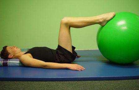 4. BALL BRIDGE WITH DOUBLE KNEE BEND: Start with ball bridge (exercise 1). Holding the bridge position, roll the ball toward the buttocks without moving the feet.