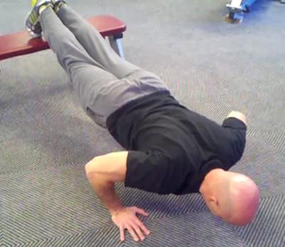 Decline Pushup Keep the abs braced and body in a straight line from toes (knees) to shoulders.