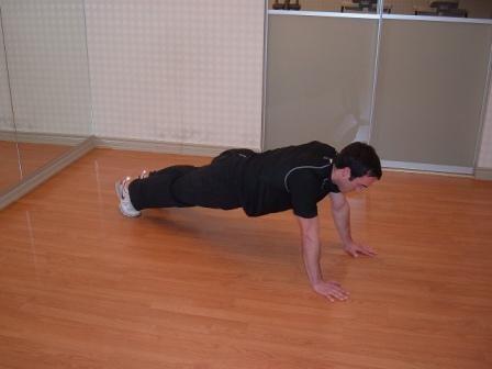 Keeping your back straight (don't round it), roll the ball as close to your chest as possible by