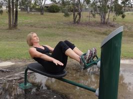 Crunches: Lie on the bench and tuck your feet under the rail provided.