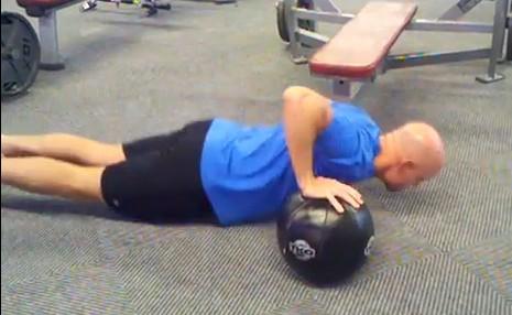 Put one hand on a medicine ball or small block and form a