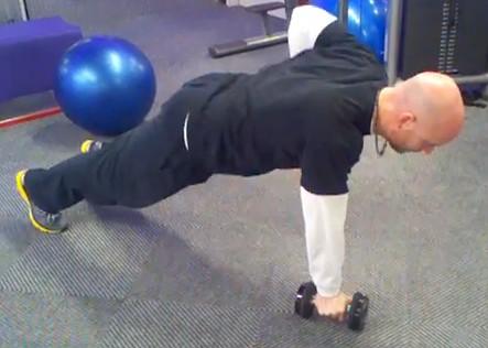 Assume the pushup position while keeping your hands on a pair of dumbbells