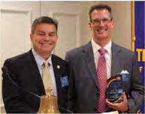 Rotary Club E Wichita: Kevin Rathert, president of the East Wichita Rotary Foundation, presented a Service Above Self award plaque to Scott Jensen, past president of the EWR Foundation.