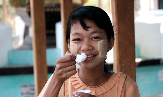Young girl in Myanmar tasting