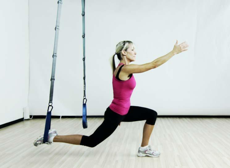 resting at the side of the body Press suspended foot down and back into a reverse lunge as