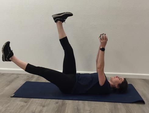 If core is strong enough, lay on floor with legs and arms extended toward the ceiling (second picture), hands