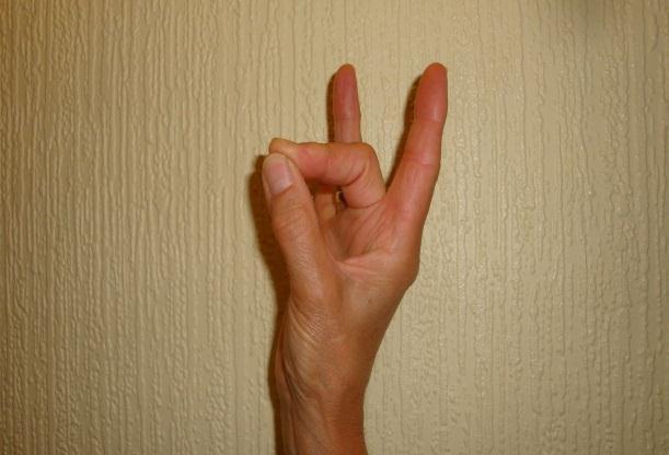 Form the letter O by touching your thumb to