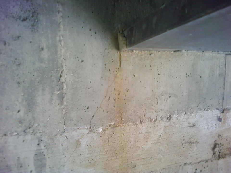 girders. These cracks run downward at a 45 angle from the corners of the bottom flange.
