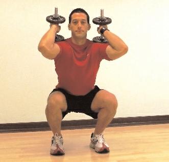 How To: Hold dumbbells on your shoulders with ends pointing directly up.