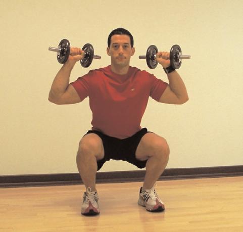 As you begin to stand back up, push the dumbbells overhead at the same time.