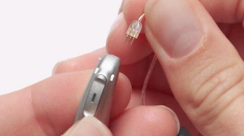 Align the 3 pins with the 3 sockets in the hearing aid.