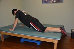 Exercise 15: Knee Push Up Starting Position: Lie on your stomach on a mat. Place your hands, palms down, on the mat at the level of your shoulders.