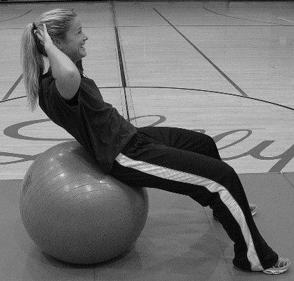Push lower back to floor. Hold medicine ball with arms extended.