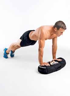 Push down hard through your heels and drive up under the sandbag until you re standing tall with the sandbag above your