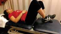 The patient activates core musculature to keep spine in neutral, and slowly slides involved heel towards buttocks.