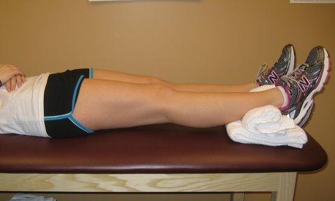 KNEE EXTENSION STRETCHING - Lying on back with surgical ankle propped on towel roll or pillow or couch arm -