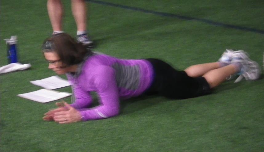 Plank on Elbows with Row and Reach Hold plank position.