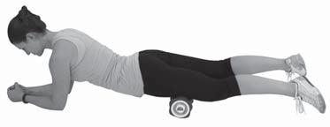 Pushing with the elbows, slowly move the roller from the knees to the hips, focusing on breathing into the muscles.