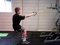 Return to the start position. Oblique Crunch Attach the resistance band to a door frame.