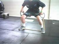 Band Deadlift Take a wide stance with your feet straight ahead.