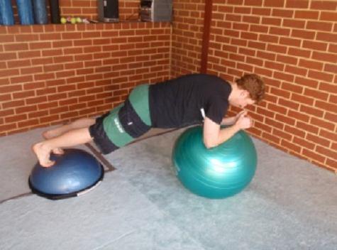 BOSU Stability Ball Bridge Perform a standard bridge but with your forearms on a stability ball and feet on a BOSU.