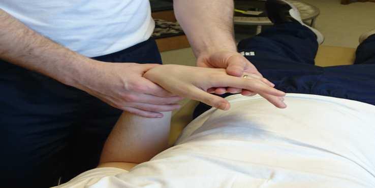 Wrist Flexion / Extension Holding the arm and hand, with the wrist